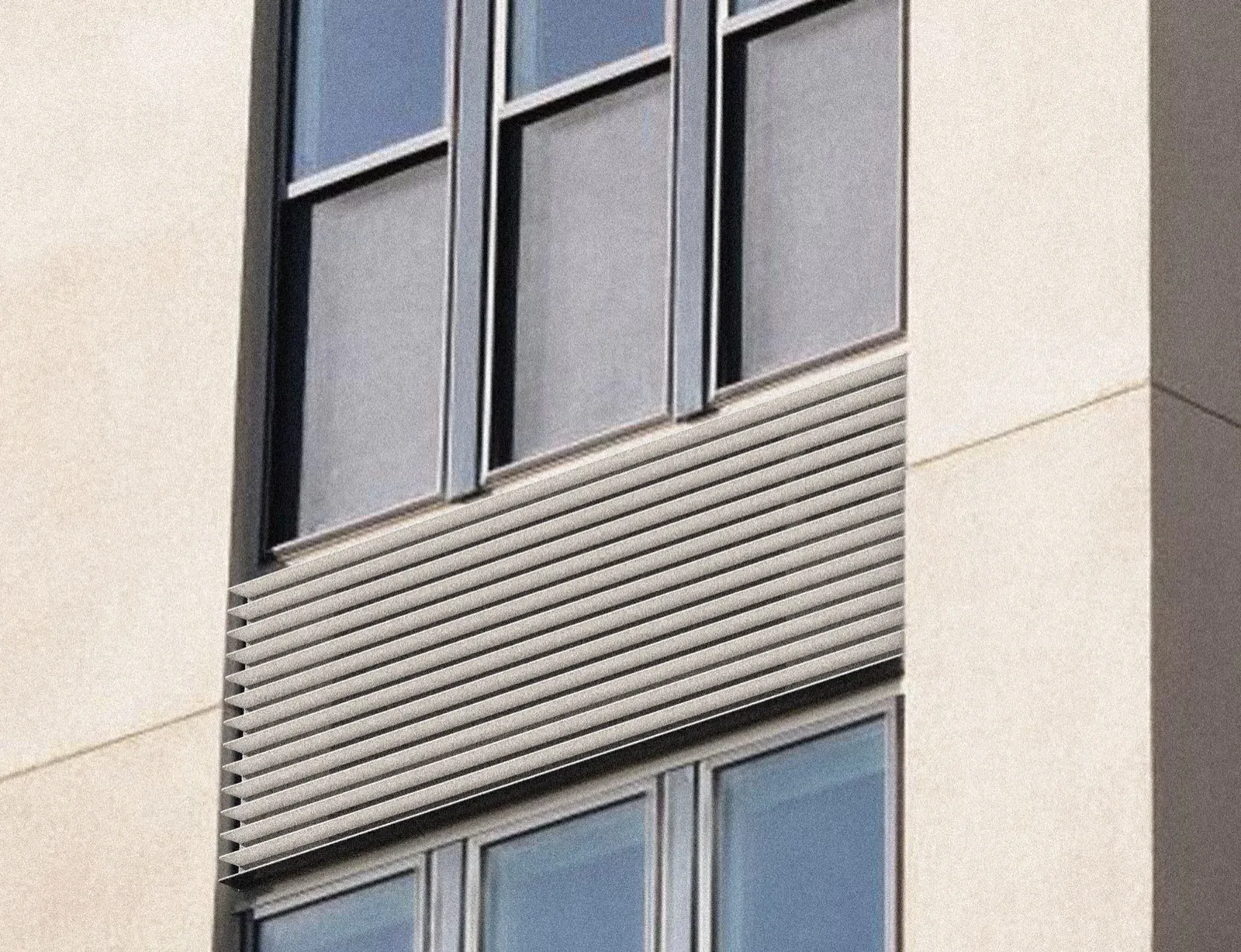 An Airform Solo unit fitted beneath a window on an apartment building